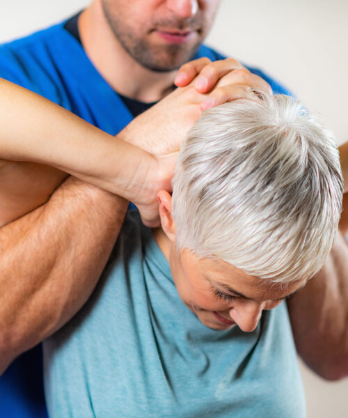 physical-therapist-stretching-senior-woman-s-neck-JPQREHT